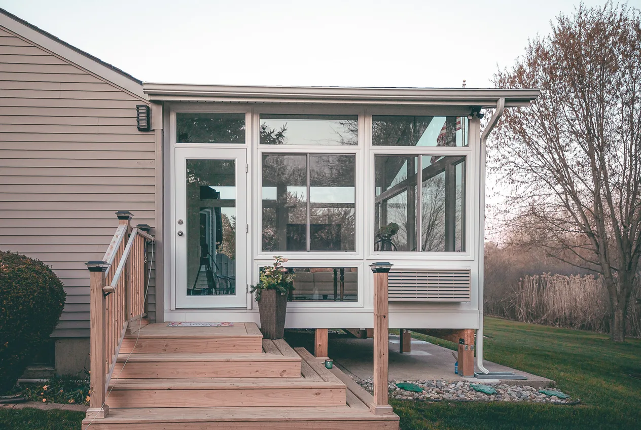 A finished high-end sunroom and deck project in calm, understated light