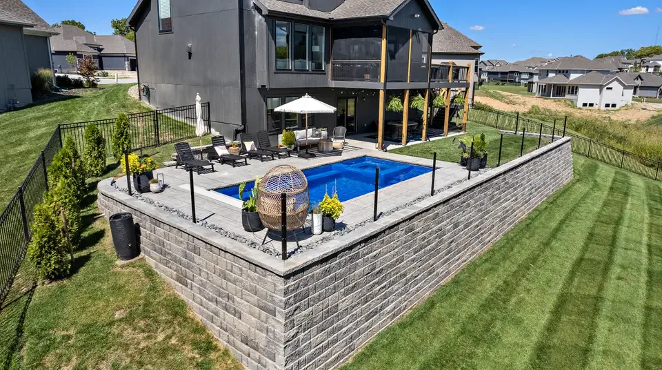 An aerial view of a finished pool and patio build, the kind of real client work behind the numbers on this page