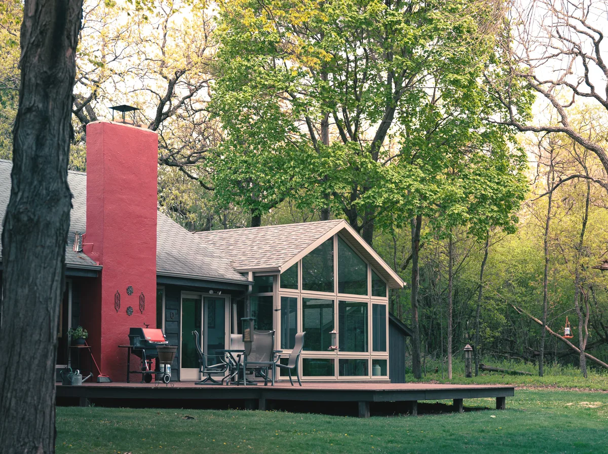 A social post of a finished sunroom addition in natural daylight
