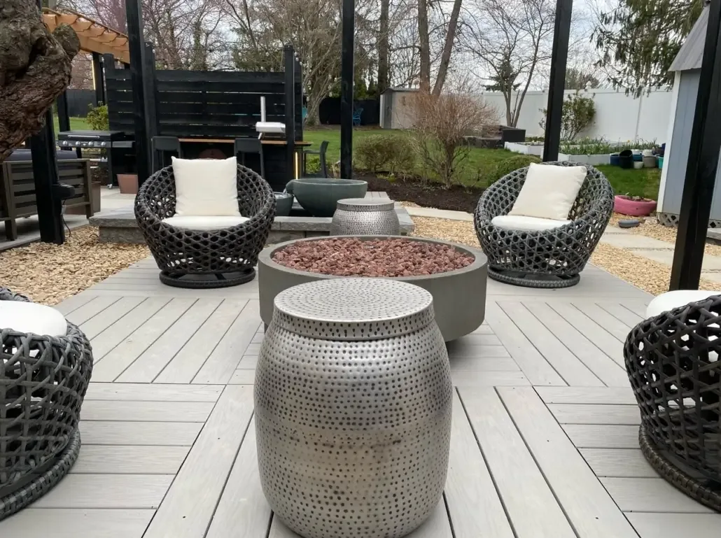 A social post spotlighting a finished patio with a fire feature and lounge seating