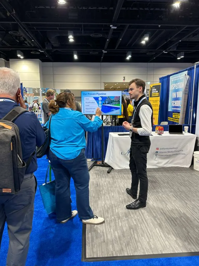 An Atlantic Media Company team member walking attendees through the lead pipeline at the booth