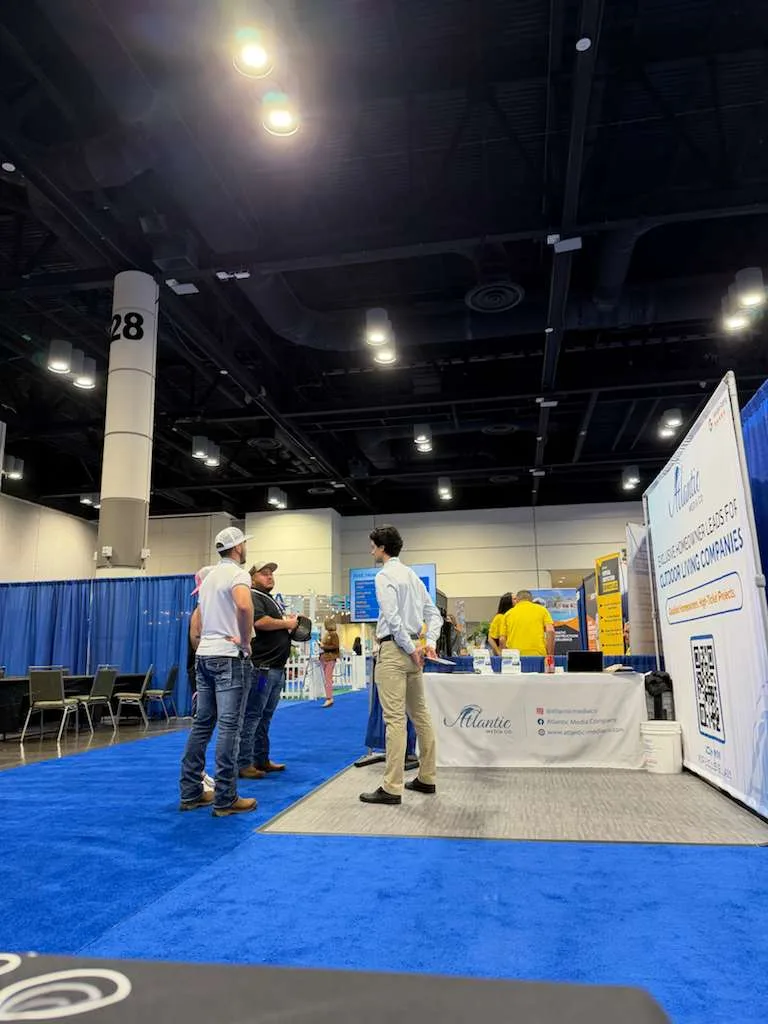 Contractors talking with the Atlantic Media Company team at their trade-show booth